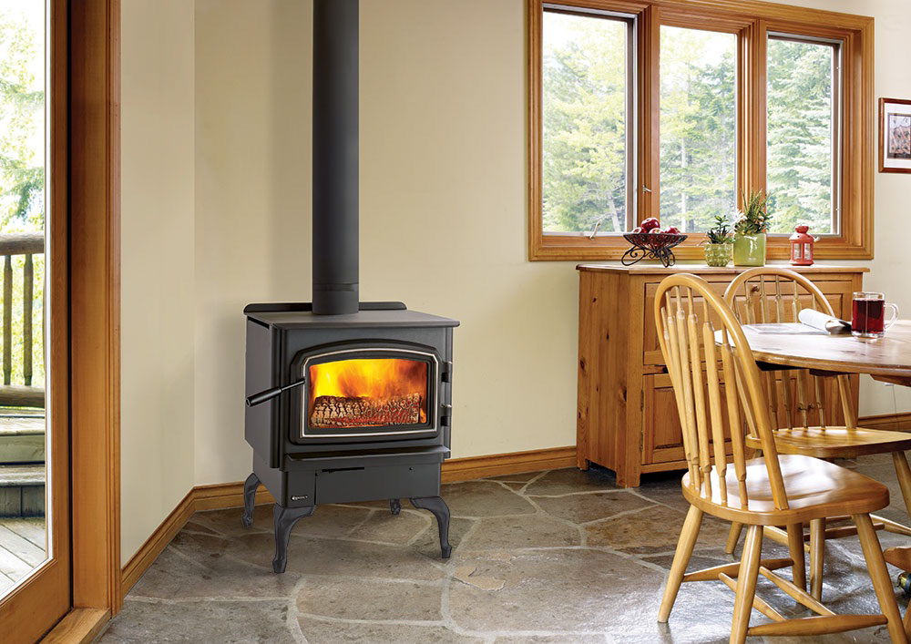 An installed wood stove with a fire burning, provided by Wood Stoves For Sale in Fairbanks, AK.