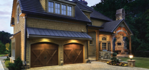 Newly installed dark wood-style garage doors on a beautiful home by Birmingham Garage Doors Installation and Repair in Birmingham, AL