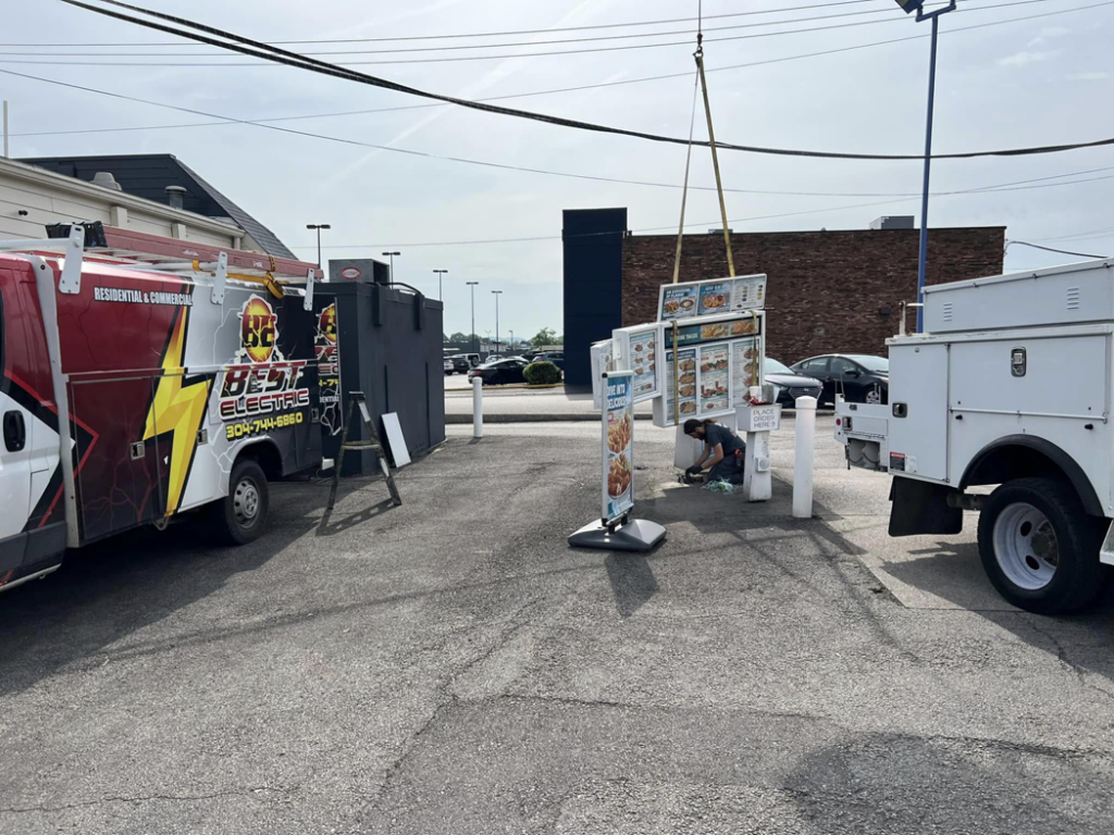 Best Electric team installing a new drive-thru menu board with a crane in Charleston, WV.