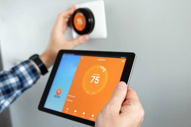 Installing a smart thermostat and setting it up with a tablet by Southside Energy in Chesapeake, VA.