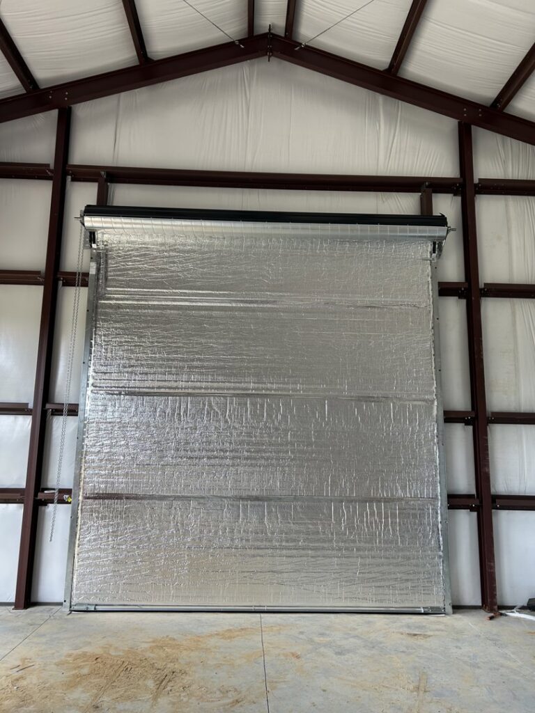 Interior view of an insulated commercial roll-up garage door installed by Chase Door Systems in Summerville, SC.