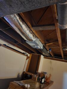 Insulated flexible ductwork and other HVAC components installed on a basement ceiling by Evergreen HVAC Comfort Solutions in Milwaukee, WI.