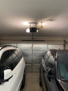 The interior view of an insulated garage door with an opener system, serviced by Foothills Garage Door Service LLC in Louisville, TN.