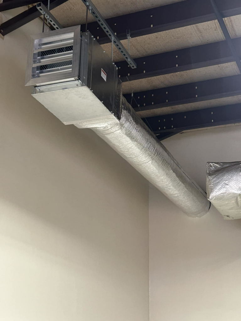 Insulated HVAC ductwork and a vent installed on a ceiling by Foremost Mechanical Services in Hartford, CT.