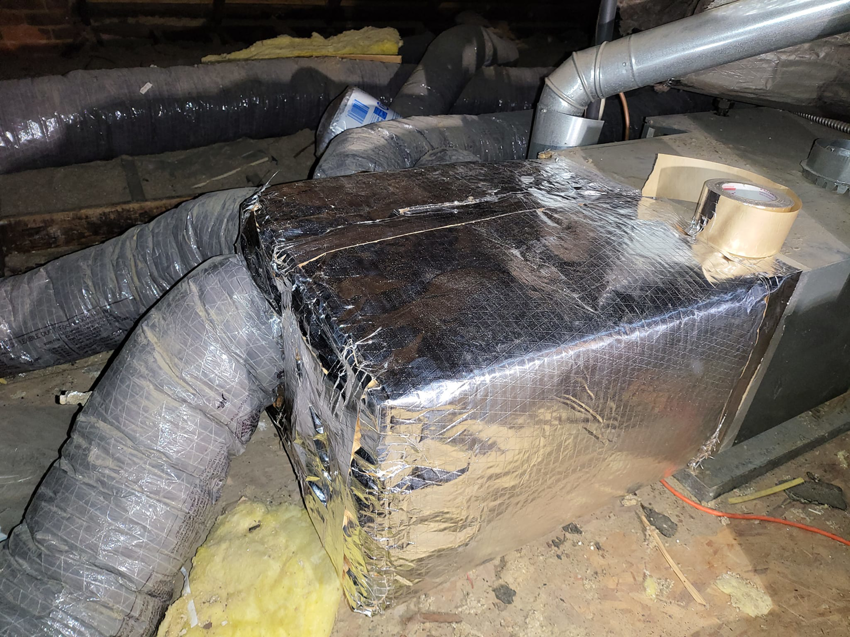 Newly installed insulated HVAC ductwork and components in an attic by Santos Heating and Cooling in St Joseph, MO.