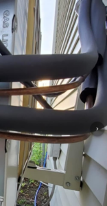 Insulated copper refrigerant lines for an HVAC system installed on the exterior of a building by Global Sheetmetal Inc in Warwick, RI.