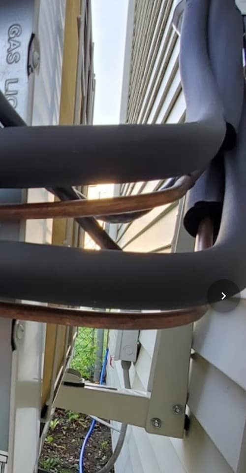 Insulated copper refrigerant lines for an HVAC system installed on the exterior of a building by Global Sheetmetal Inc in Warwick, RI.