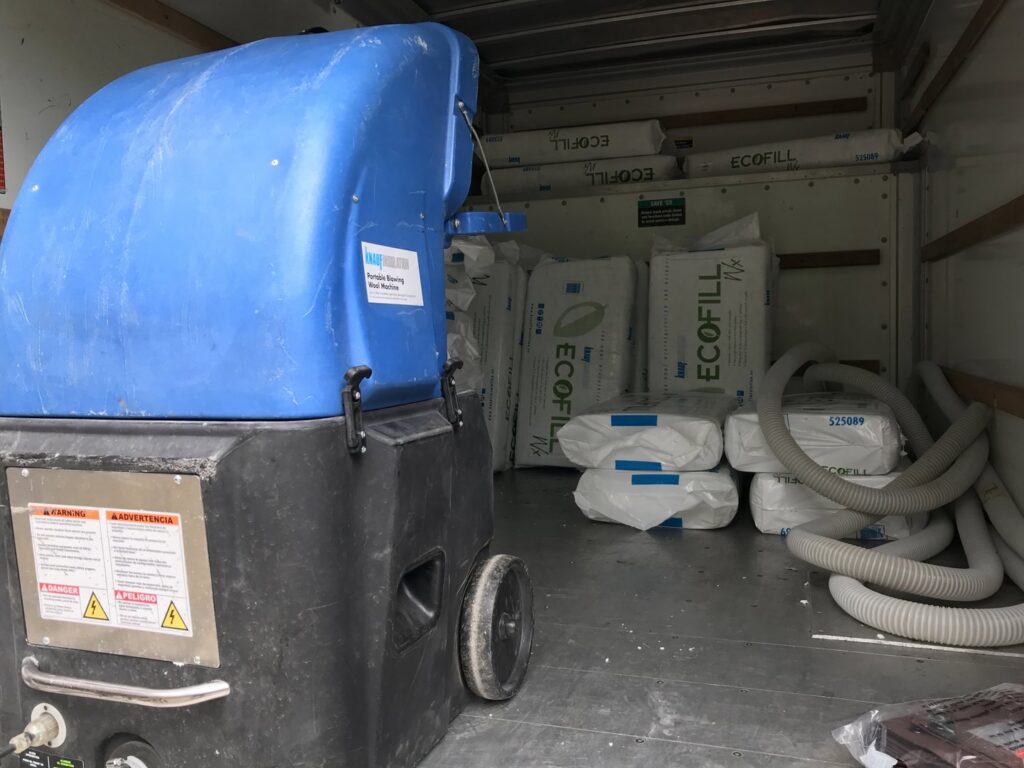 Insulation blowing machine and bags of Ecofill insulation inside a truck, used by The Squirrel Guys in Birmingham, AL.