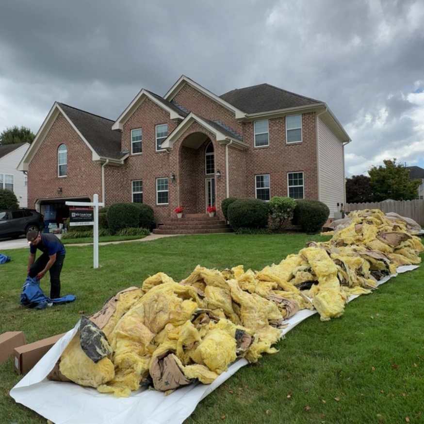 A large pile of old insulation removed from a home during wildlife remediation by Chesapeake Pest Control in Chesapeake, VA