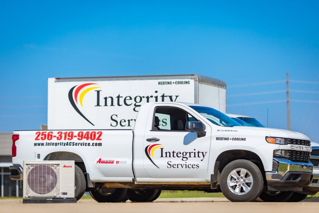 An Integrity Services Heating and Cooling company truck with an Amana AC unit in front, serving Madison, AL.