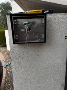An intercom and access control system being installed on a wall by A1 Security Gate & Intercom in Dallas, TX
