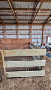 Interior barn fencing and livestock pen constructed with wood and wire mesh by Row Fencing and Services in Williston, ND.