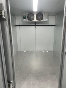 Interior view of a commercial walk-in freezer with two refrigeration units by CC Mechanical in Portland, ME.