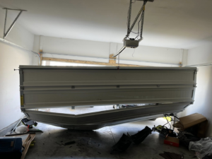 An interior view of a severely damaged garage door requiring repair or replacement by J&S Garage Door Services in Franklin, TN.