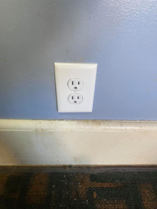 A newly installed interior duplex electrical outlet on a light blue wall by Pierce Electric, LLC in Fayetteville, NC