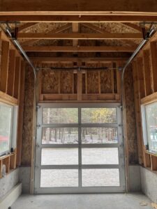 Interior view of a white full-view glass garage door installed in a new build by Remarkable Door Company in Spokane, WA.