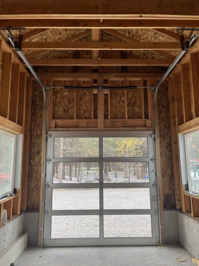 Interior view of a white full-view glass garage door installed in a new build by Remarkable Door Company in Spokane, WA.