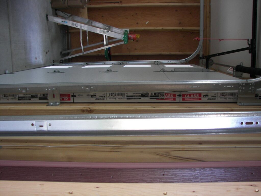 Interior view of a garage door installation in progress, showing panels and tracks by Sonoran Garage Doors in Mesa, AZ