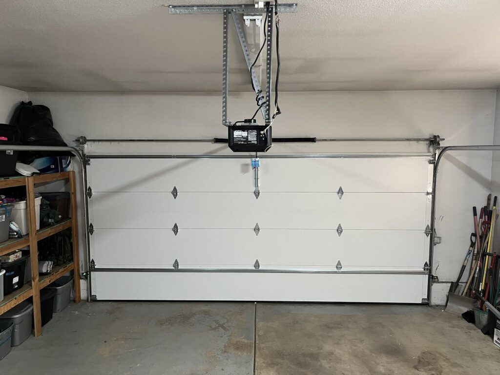 An interior view of a white garage door and a newly installed LiftMaster garage door opener by SCI Door in Yakima, WA