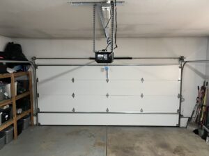An interior view of a white garage door and a newly installed LiftMaster garage door opener by SCI Door in Yakima, WA