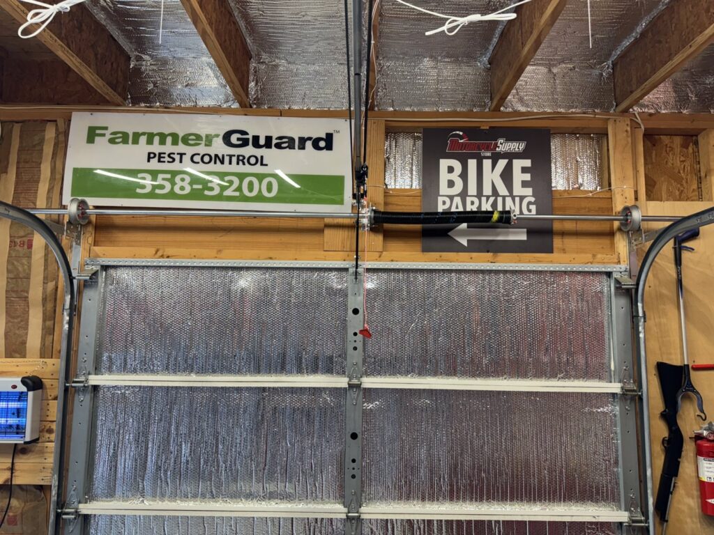 Interior view of a garage door showing springs and tracks, installed by Platinum Garage Door Services in Helena, AL