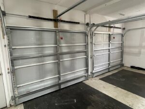 Interior view of two garage doors showing tracks and springs, serviced by Precision Garage Door of Charleston in Charleston, SC.