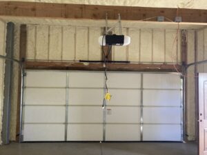 Interior view of a newly installed garage door with an opener by Anew Garage by Jon's Garages in Surprise, AZ.