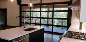 Modern kitchen with a large glass garage-style door installed by Garage Door Technologies in Minneapolis, MN