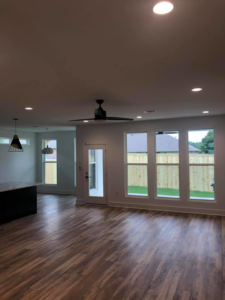 A modern living space with recessed lighting and a ceiling fan installed by Hammett Electric, Inc. in Conway, AR.