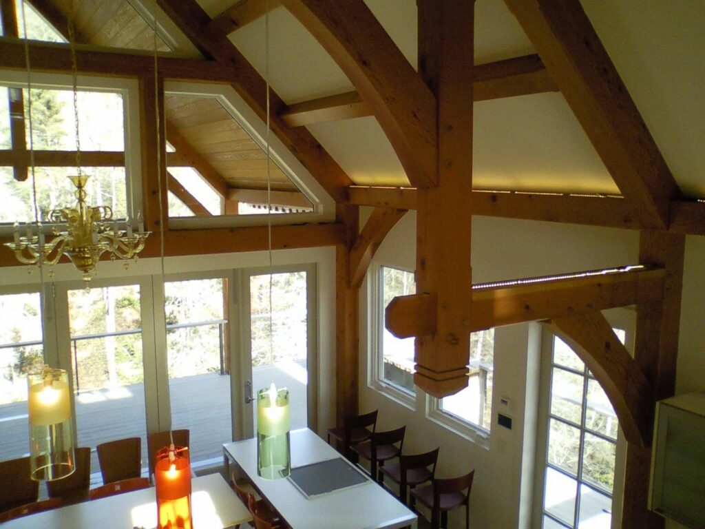 An interior room with exposed wooden beams and various light fixtures, showcasing electrical work by Greif Electric Company in Dolgeville, NY.