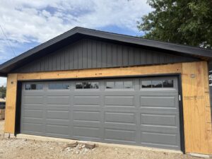 Interior view of two newly installed white garage doors by Ozarks Overhead Door & More in Springfield, MO.