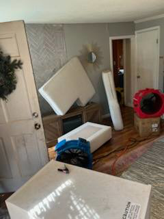 Interior room prepared for pest control heat treatment with fans and furniture moved by All Seasons Pest Control LLC in Southgate, MI.