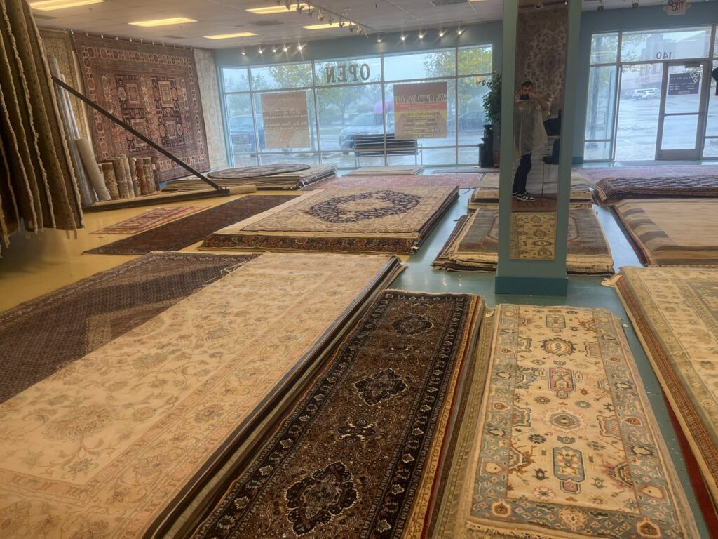 The interior of the Yas Rugs showroom displaying a wide selection of rugs in Lexington, KY.