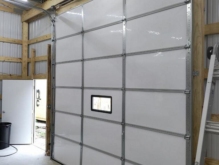 Interior view showing the tracks and hardware of a commercial garage door installed by Horton & Hill Garage Door Specialists LLC in Sapulpa, OK.