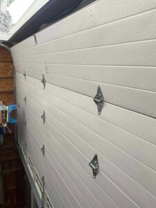 Interior view of a garage door showing the panels and hinges, installed by Door Serv Pro in Inwood, WV.