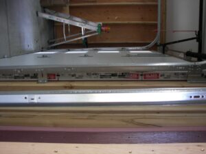 An interior view of garage door panels and track system, showing a recent installation or service by Sonoran Garage Doors in Mesa, AZ