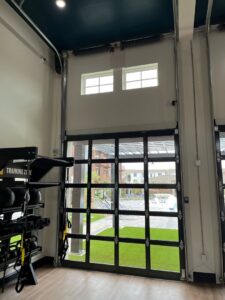 Interior view of a modern glass garage door in a training zone, installed by Precision Door Service of Huntsville, AL.