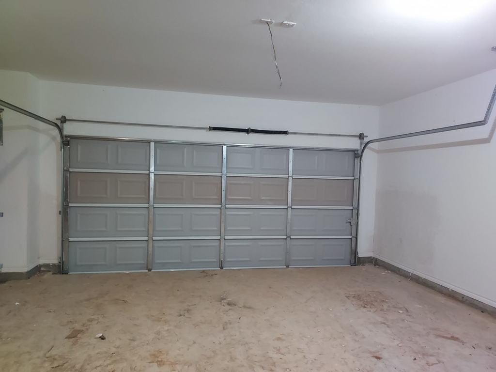 An interior view of an installed garage door with tracks by Zee's Garage Doors in Oklahoma City, OK.