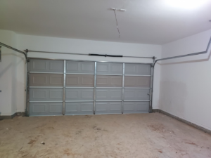 An interior view of an installed garage door with tracks by Zee's Garage Doors in Oklahoma City, OK.