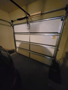 Interior view of a newly installed white panel garage door, showcasing work by Mountain Fox Garage Doors in Colorado Springs, CO.