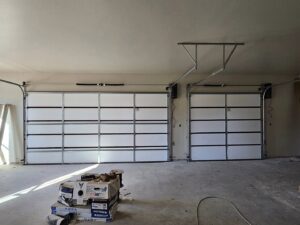Interior view of two new garage doors installed with tracks in a garage by Total Door Solutions in Yukon, OK