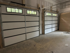 Interior view of two newly installed white garage doors with windows by Up Garage Door in Nashville, TN.