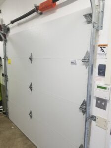 An interior view of a newly installed garage door panel, showing the mechanism, by Xpress Doors LLC in Salem, OR