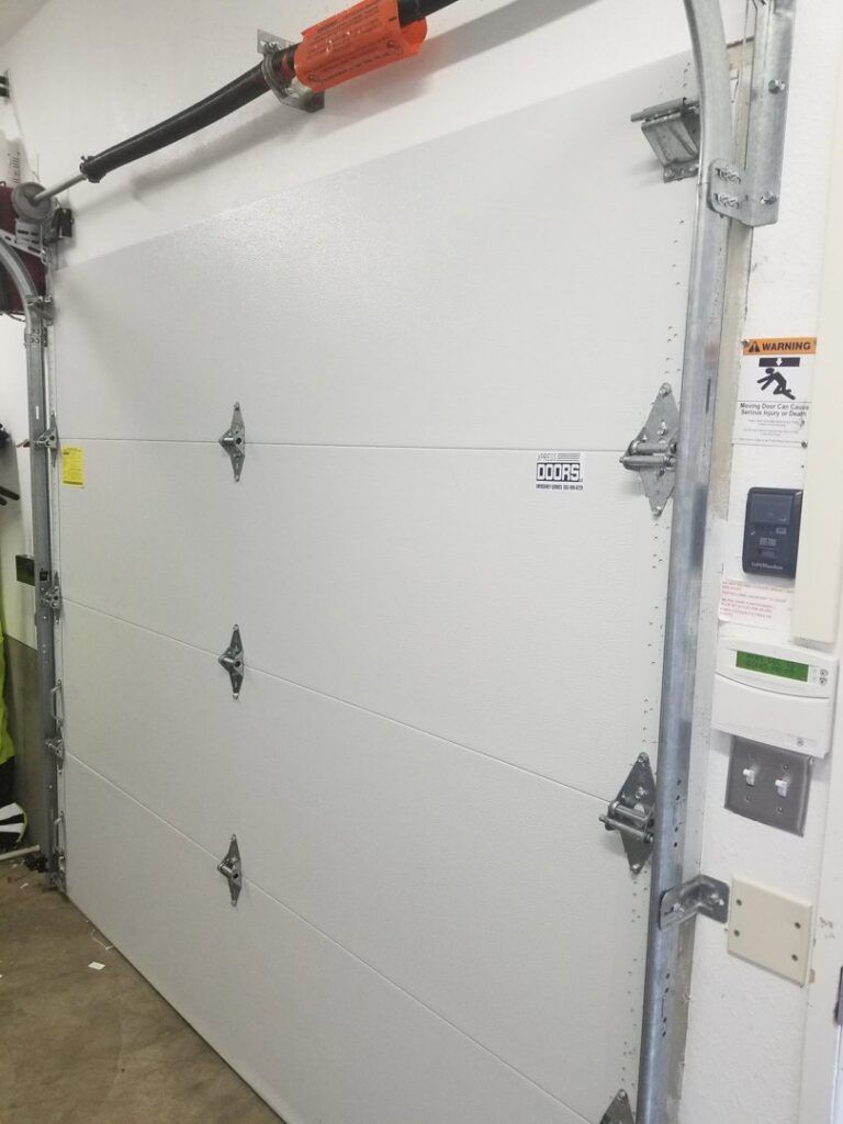 An interior view of a newly installed garage door panel, showing the mechanism, by Xpress Doors LLC in Salem, OR