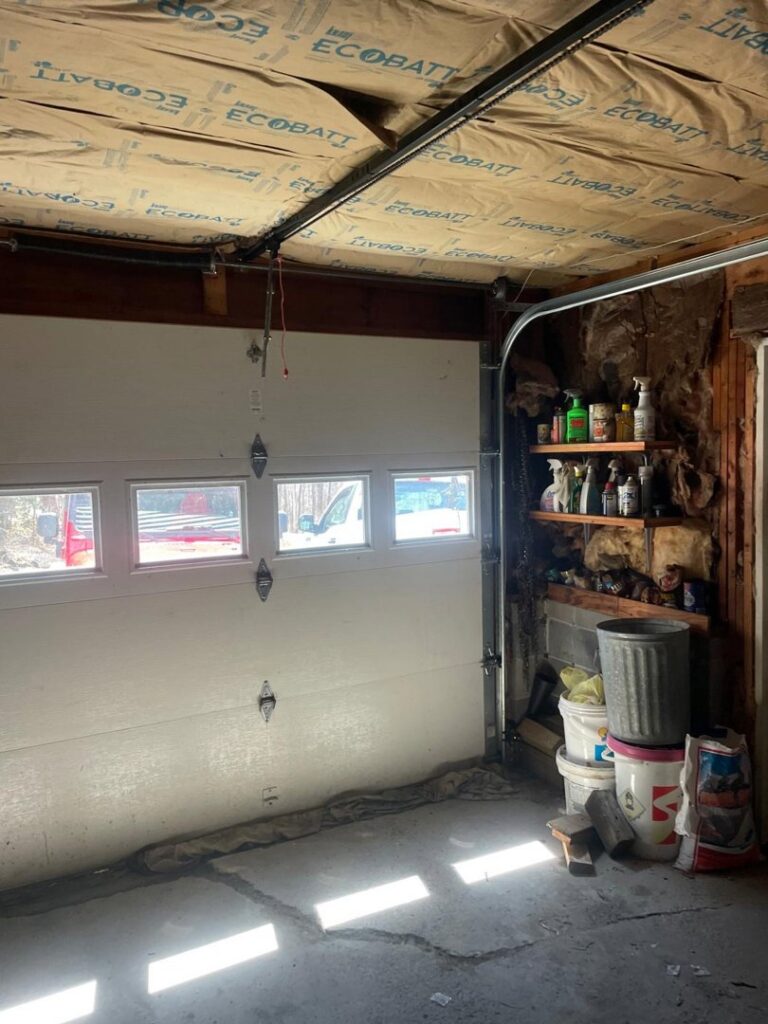 An interior view of a residential garage door and its tracks, showcasing the work environment for Integrity Garage Door Repair in Clearwater, FL.