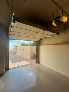 An interior view of an open garage door, showcasing the opener mechanism and panels, serviced by 101 Garage Doors in Phoenix, AZ.