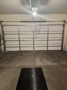An interior view of a white garage door showing the panels and support beams, installed by 4 Sons Garage Door in Phoenix, AZ.