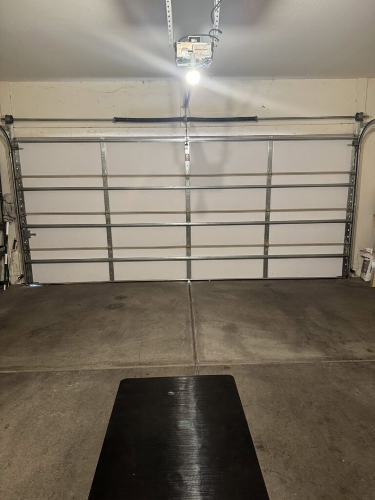 An interior view of a white garage door showing the panels and support beams, installed by 4 Sons Garage Door in Phoenix, AZ.