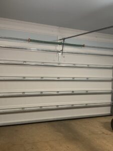 Interior view of a white garage door showing springs and tracks, serviced by Precision Garage Door Service of Mobile in Mobile, AL.