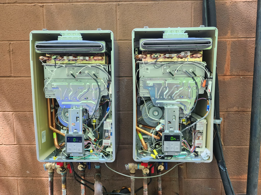 Internal view of two Rinnai tankless water heaters being serviced by Facility Doctors in Raleigh, NC